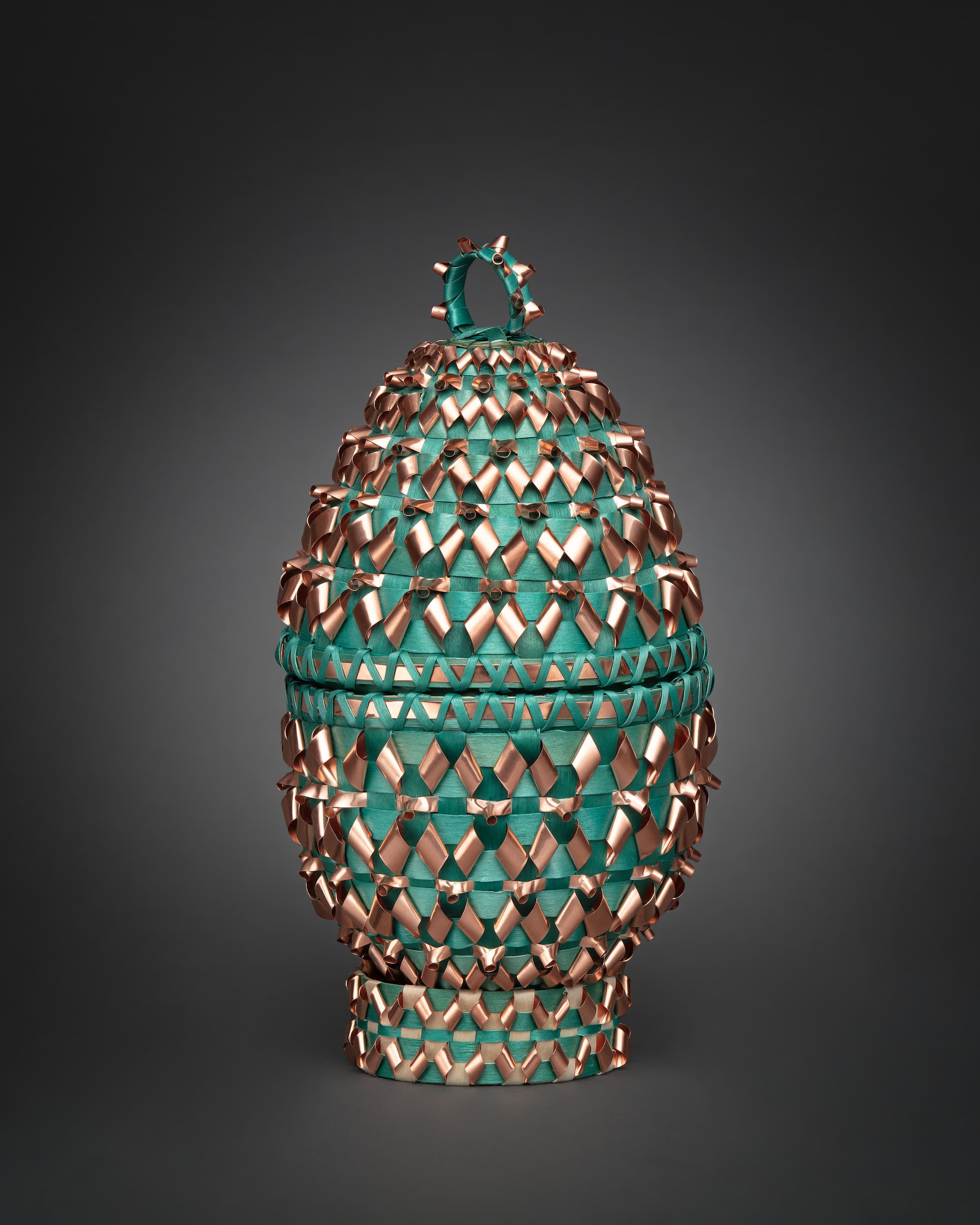a decorative copper and emerald egg-shaped basket
