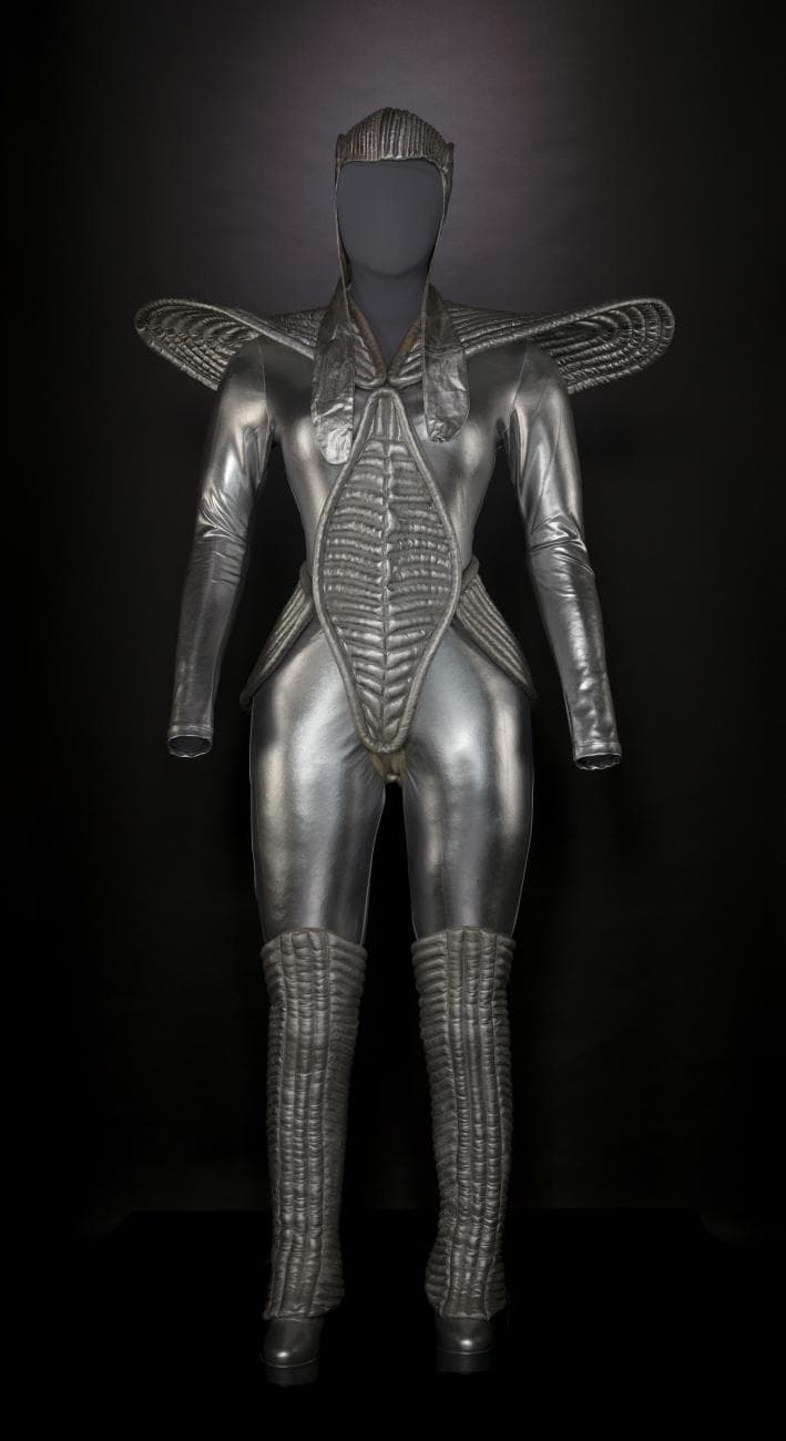 metallic silver costume with large shoulder protrusions